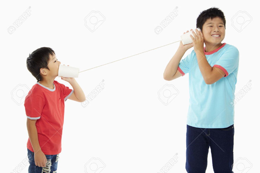 22628653-Two-boys-playing-with-a-paper-cup-phone-Stock-Photo